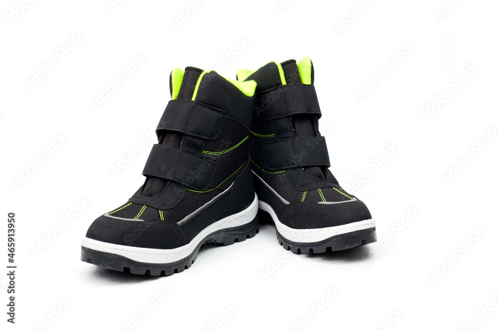 Demi-season teenage boots in dark gray with Velcro fasteners shot against a white background. Demi-season teenage boots in dark gray with Velcro fasteners shot against a white background.