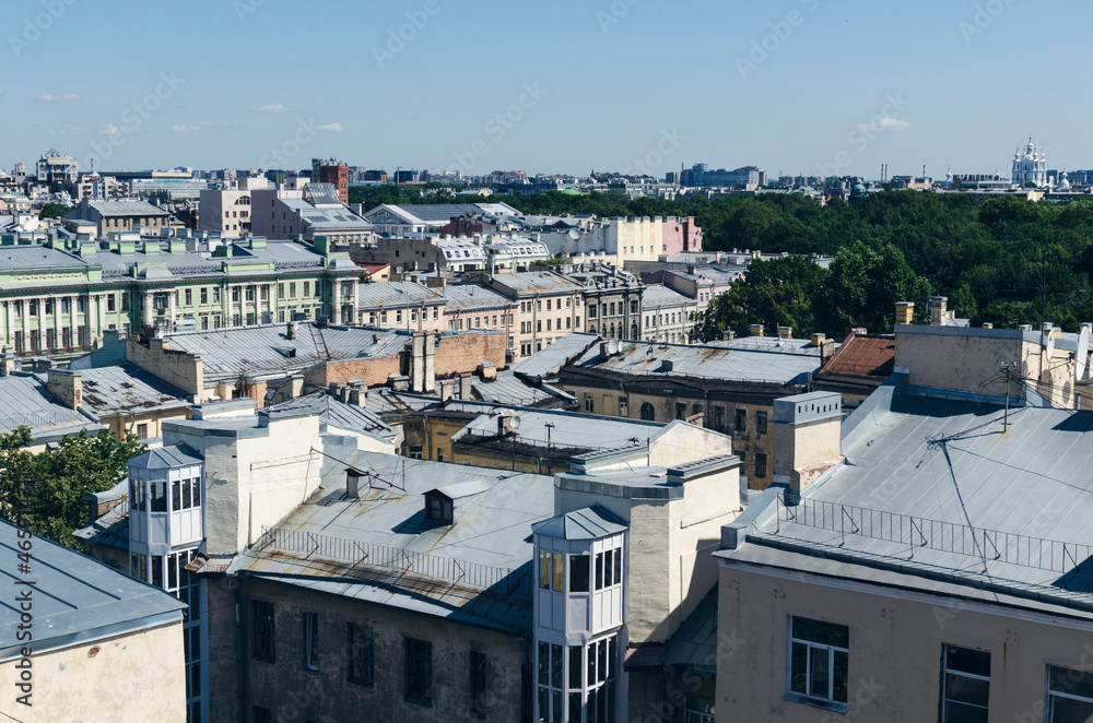 Fototapeta premium RUSSIA, Saint Petersburg: Scenic aerial cityscape view of the sunny city roofs and architecture with blue clear sky