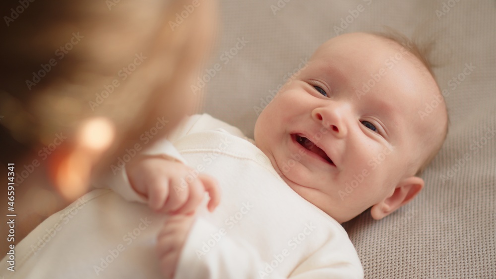 Newborn baby happy to looking on his mom . Happy mother spends time with her child. Mother playing with an infant kid. Infant with blue eyes happy being with mama. Maternity and childcare concept. Newborn baby happy to looking on his mom . Happy mother spends time with her child. Mother playing with an infant kid. Infant with blue eyes happy being with mama. Maternity and childcare concept.