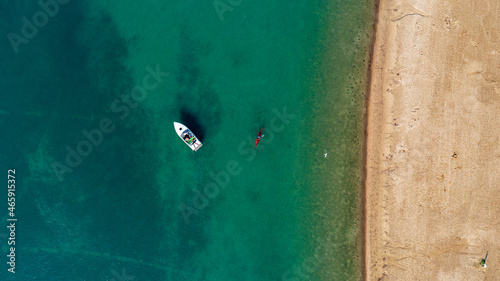 Overhead aerial view of a fisherman, a kayaker and a flying seagull at Belle Isle Beach.  © Nicholas Worden