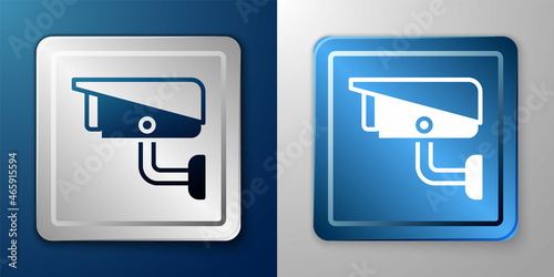 White Security camera icon isolated on blue and grey background. Silver and blue square button. Vector