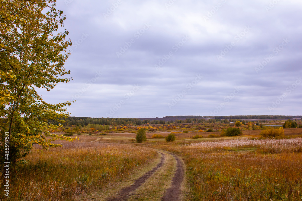 Roads of the Kurgan region. Dirt roads in autumn fields in Russia.