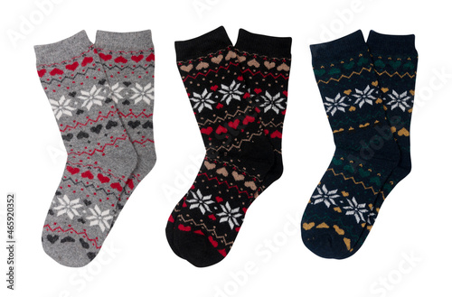 three pairs of woolen socks with cute christmas pattern isolated on white background