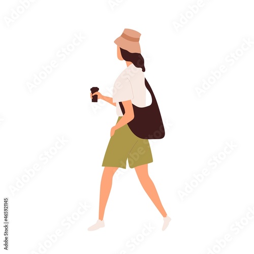 Woman walking with takeaway coffee cup in hands. Young modern person going an...