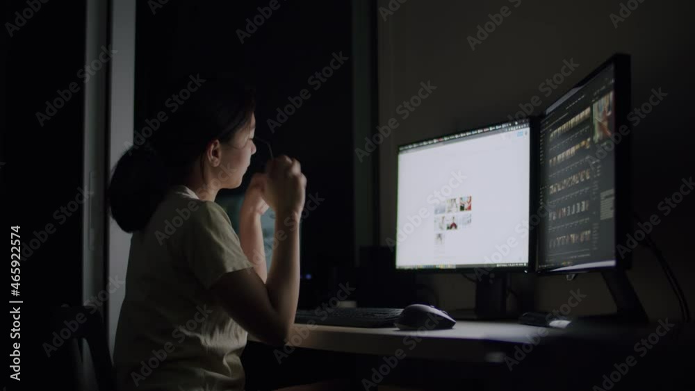 Asian woman work late at night and feel sleepy at the desk in a darkroom at home. Asian woman work late at night and feel sleepy at the desk in a darkroom at home.