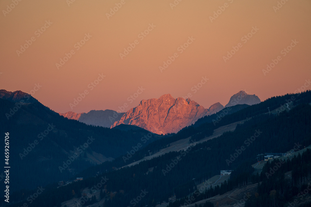 beautiful orange sunsrise on the mountains with view of the alps and frost in the valley
