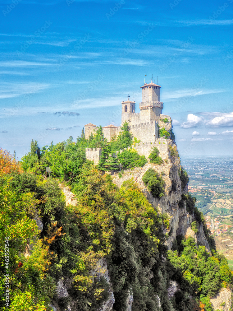 San Marino castle on a cliff during the day, sunny