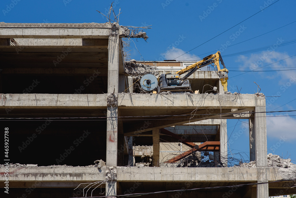 a construction car breaks down a building, building under construction