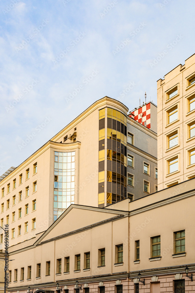 facades of high-rise restored buildings on Bolshaya Lubyanka street in center of Moscow city at sunset.