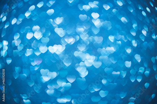 Background bokeh in the form of hearts in blue. Copy space for text. The concept of romance and love. Valentine's Day. Shiny texture background. Festive background.