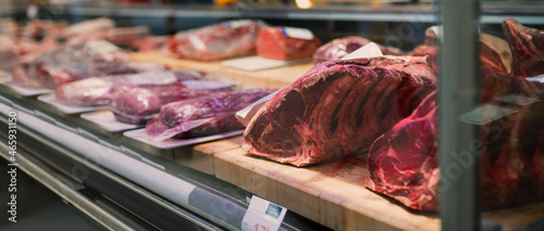 Bild auf Leinwand Showcase with raw meat in butcher shop.
