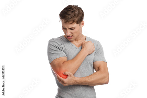 Canvas Print Sad young caucasian guy athlete suffering from elbow pain, presses hand to sore