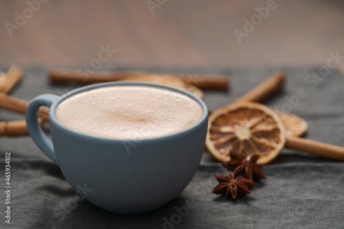 Hot chocolate in a blue cup with natural christmas decorations