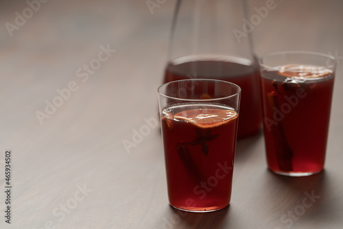 Mulled wine in tumbler glasses on walnut table with copy space