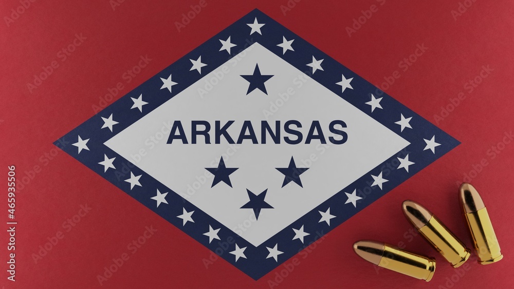 Three 9mm bullets on the bottom right corner on top of the United States state flag of Arkansas