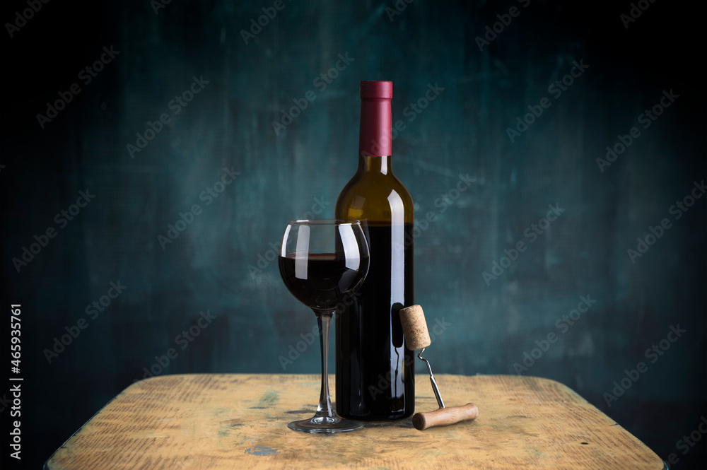 the still life with red wine, bottle, glass and old barrel