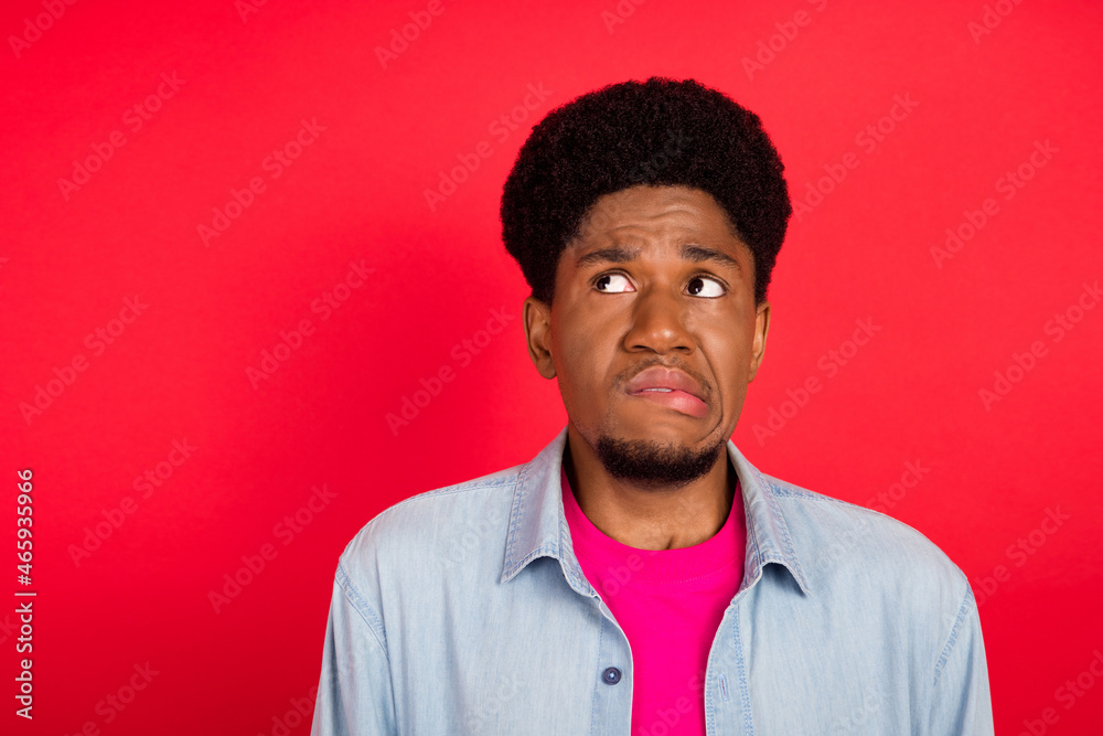 Portrait of attractive scared afraid brunet guy worrying biting lip overthinking copy space isolated over bright red color background Portrait of attractive scared afraid brunet guy worrying biting lip overthinking copy space isolated over bright red color background