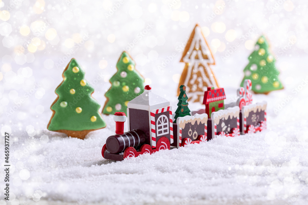 Christmas toy train with a Christmas tree and gifts.