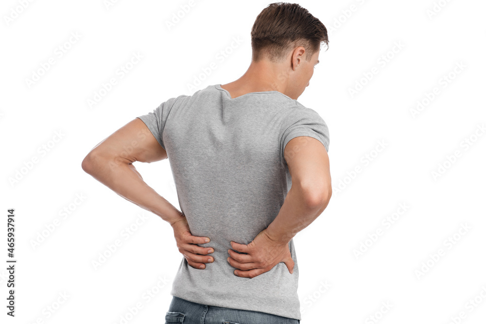 Young european man suffering from kidney pain, pressing his hand to back, isolated on white background Young european man suffering from kidney pain, pressing his hand to back, isolated on white background