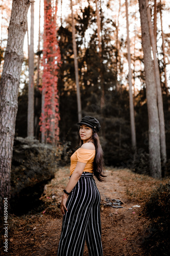 Obraz na plátně Young elegant Hispanic woman wearing a stylish newsboy female cap posing in the