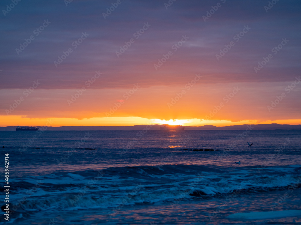 Picturesque seascape during sunset, Golden shining reflection of sunlight on the sea.