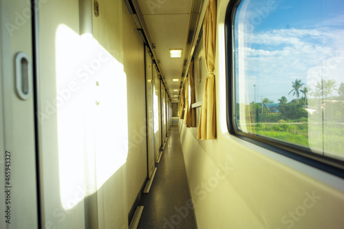Narrow corridor in front of the room inside the first class train © Phichat