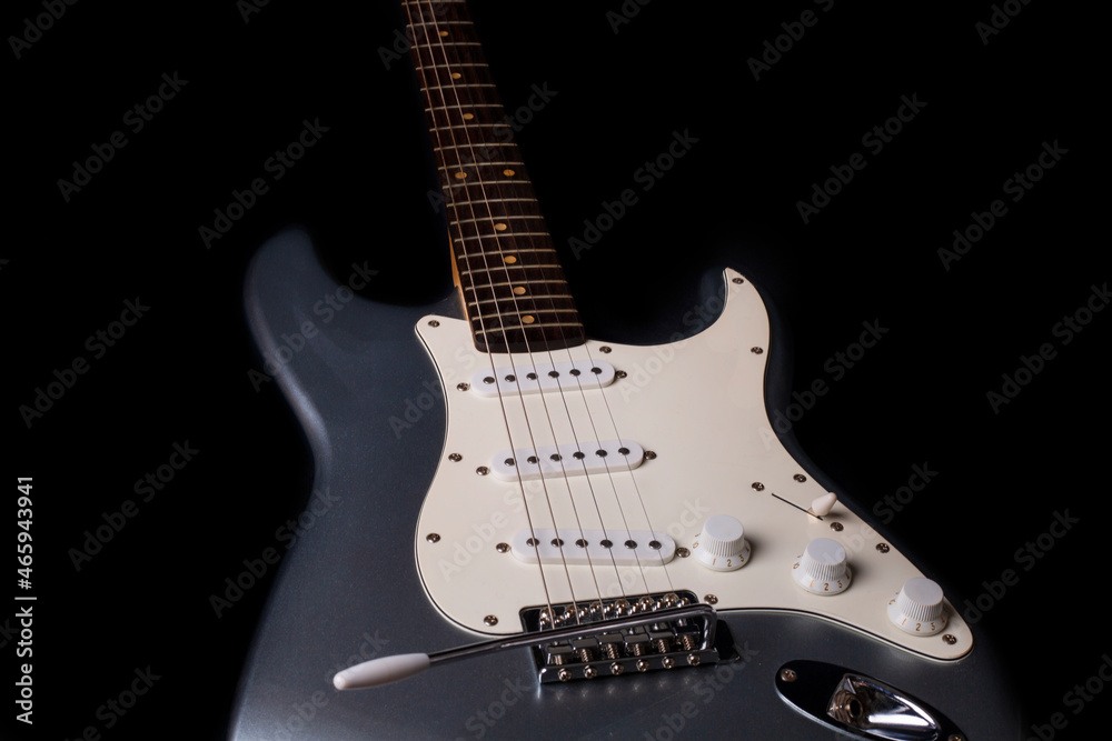 Silver electric guitar isolated on black background
