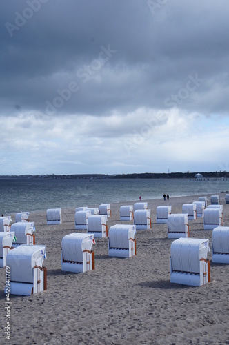 beach chairs with rising storm