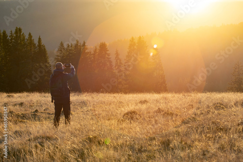 Hiker in magic autumn light