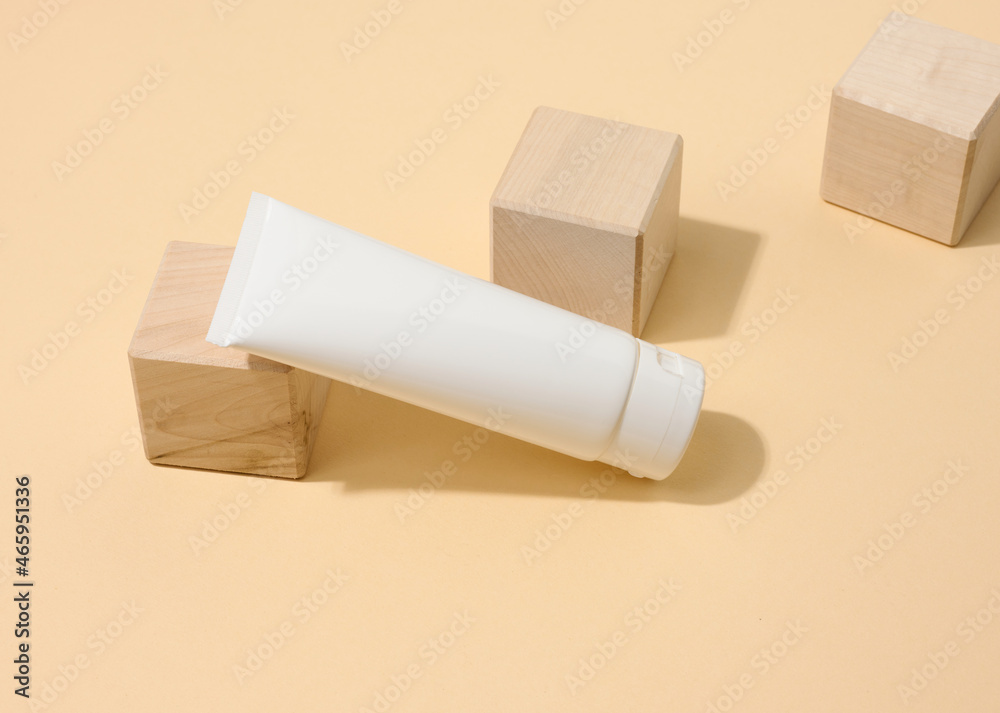 empty white plastic tubes for cosmetics on a white table. Packaging for cream, gel, serum, advertising and product promotion empty white plastic tubes for cosmetics on a white table. Packaging for cream, gel, serum, advertising and product promotion