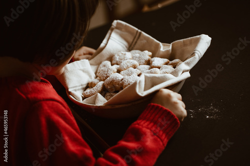 Child looks at a basket of cookies