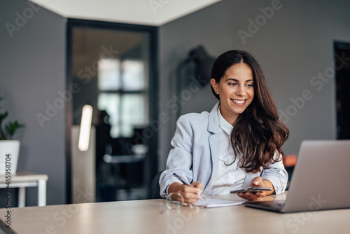 Adult woman, having a busy day at work photo