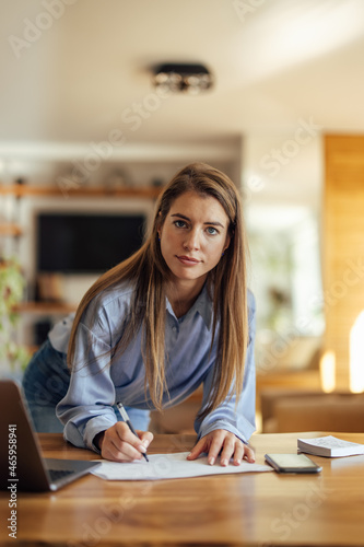 Shot of adult woman, working hard from home