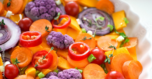 Vegetable background.Orange and purple vegetables for baking close-up. Cauliflower, red onion, pumpkin chopped for baking, homemade healthy food, vegan food background