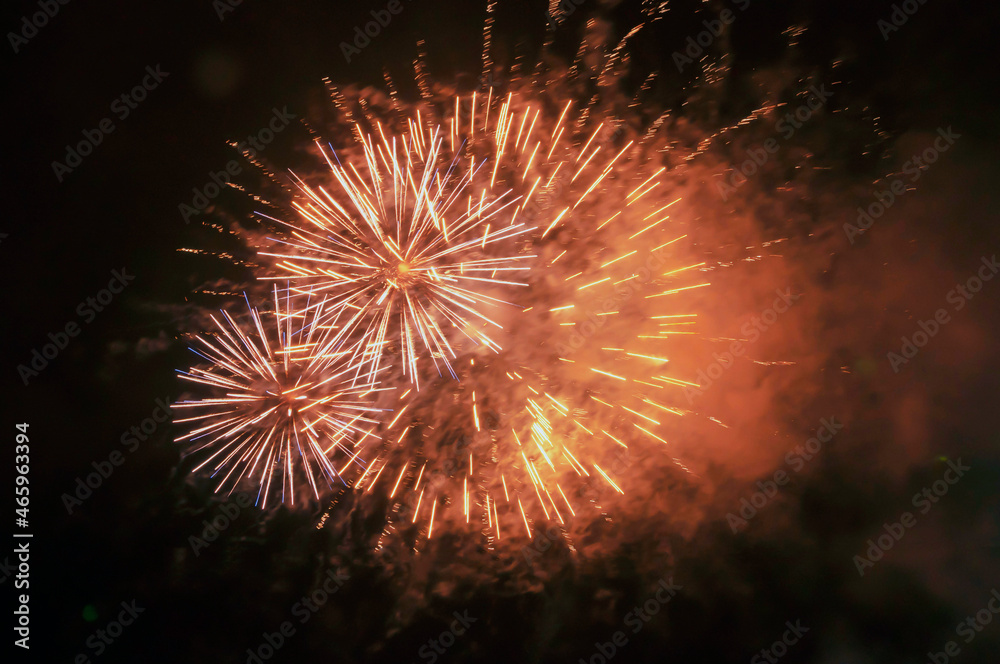 explosions of yellow fireworks against the black night sky. Holiday concept, background, texture. explosions of yellow fireworks against the black night sky. Holiday concept, background, texture.