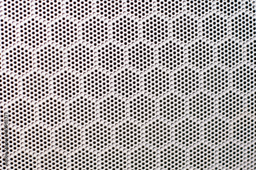 the background is a texture of gray material with round black cells from a car speaker. The concept of a page filling template.