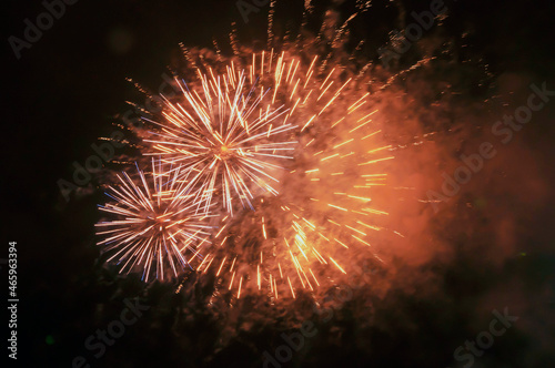 explosions of yellow fireworks against the black night sky. Holiday concept, background, texture.