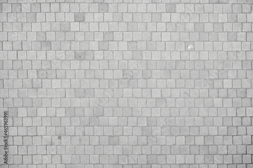 Texture of small cobblestones of a sidewalk or street. Gray cobblestones. Cement squares. Square stone. Texture for matte painting.