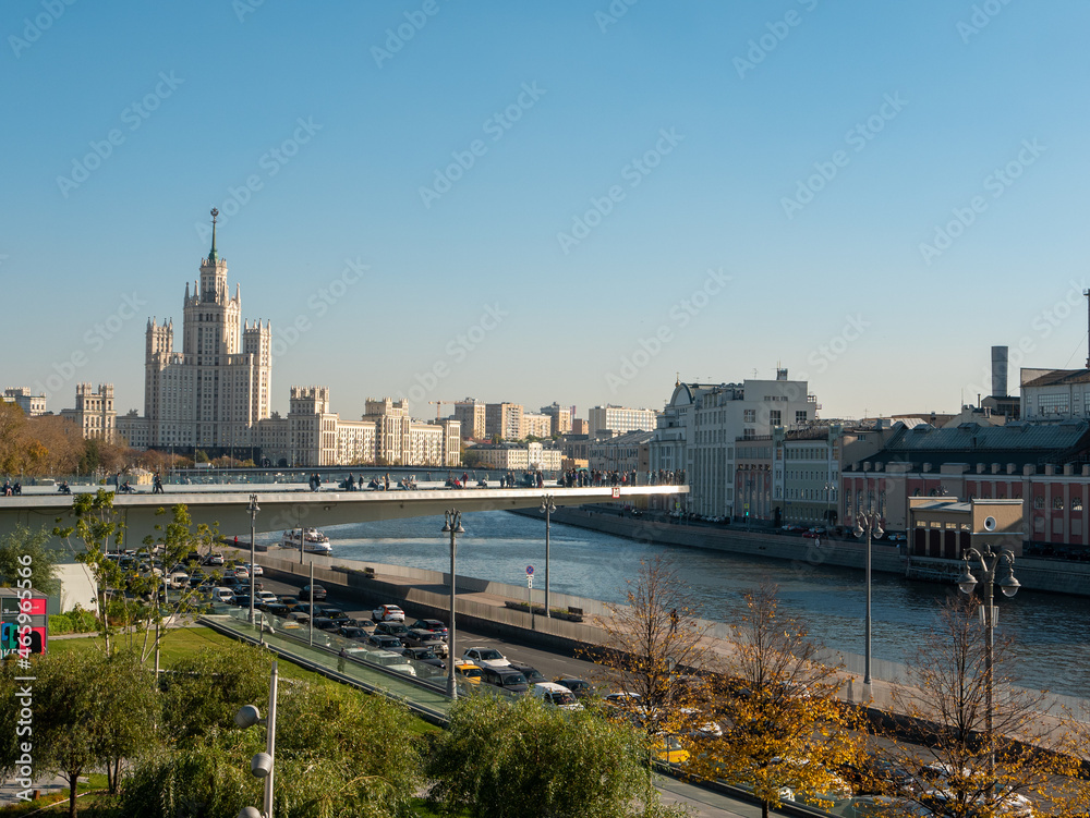 Moscow, Russia - October 5, 2021: Zaryadye Park. Floating bridge with walking people against the blue sky on an autumn day