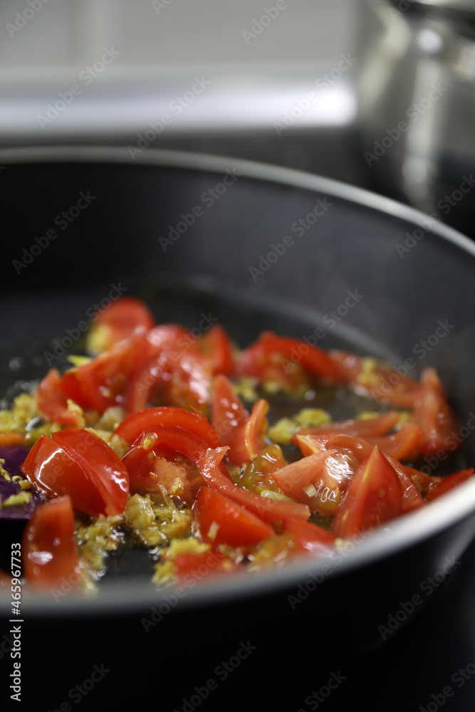 Making a sauce with olive oil, garlic and tomatoes Making a sauce with olive oil, garlic and tomatoes