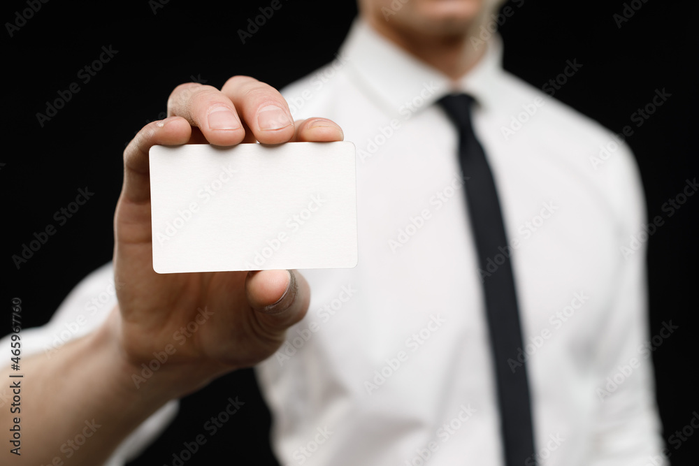 Young businessman is showing the word. Your text here