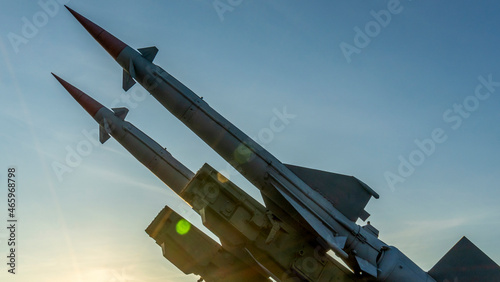 Two combat missiles aimed at the sky. Old ballistic missile launcher on blue sky background.