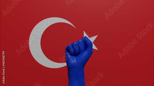 A single raised blue fist in the center in front of the national flag of Turkey photo