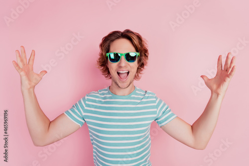 Excited funny funky crazy glad tourist man raise hands open mouth enjoy weekend party