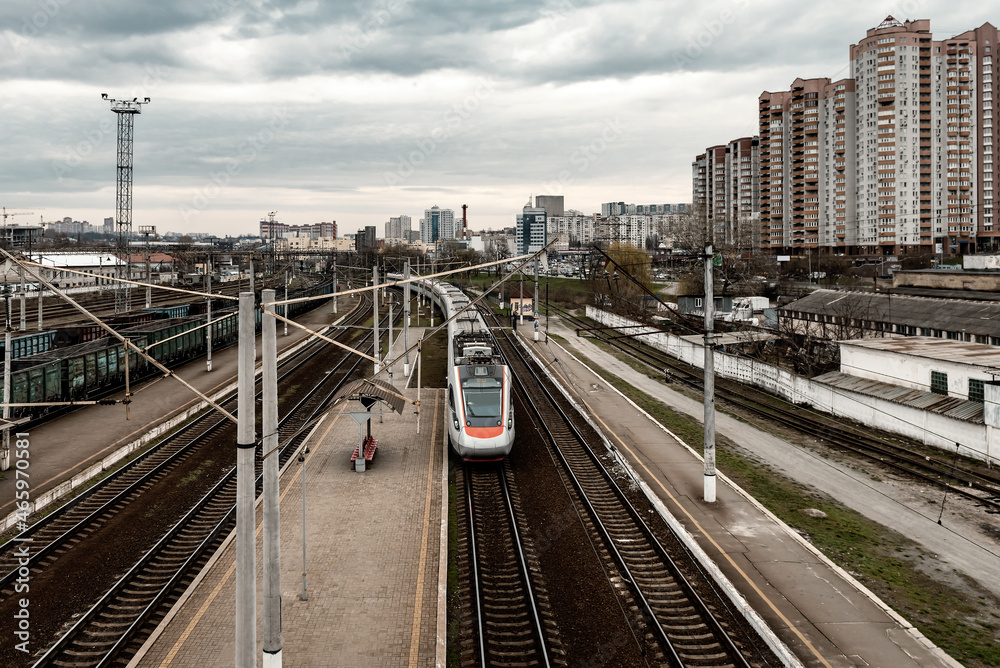 a fast passenger train travels through the city