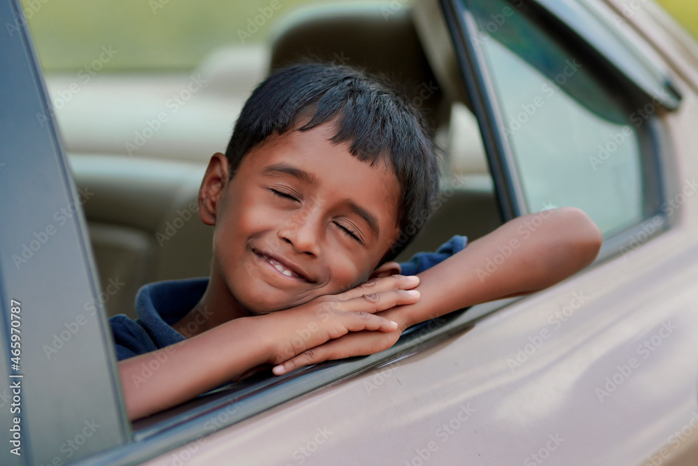 Cute Indian Child waving from car window. Cute Indian Child waving from car window.