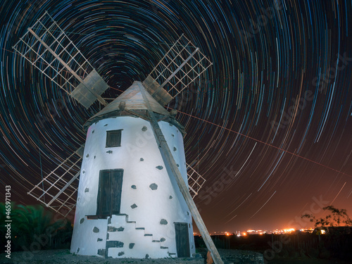 Windmill in the night surrounded by stars photo