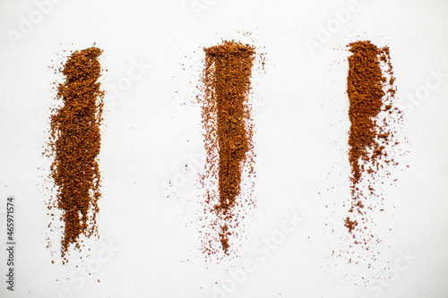  Three types of coffee grind on a white background. Ground coffee. Ground coffee under a cup. Ground coffee for espresso.