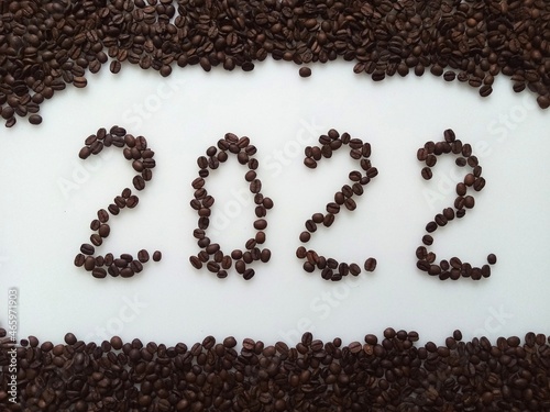 Numbers 2022 lined with coffee beans on White background. 