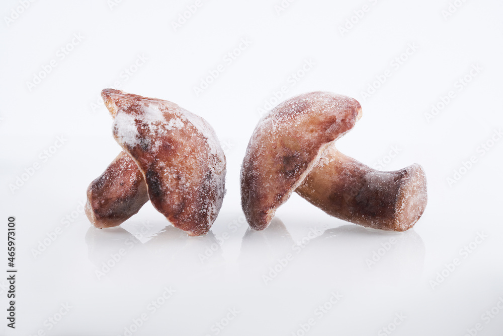 Frozen mushrooms close-up isolated on white background, brown champignon prepared for cooking Frozen mushrooms close-up isolated on white background, brown champignon prepared for cooking